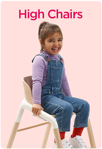 Young child in a modern high chair smiling.